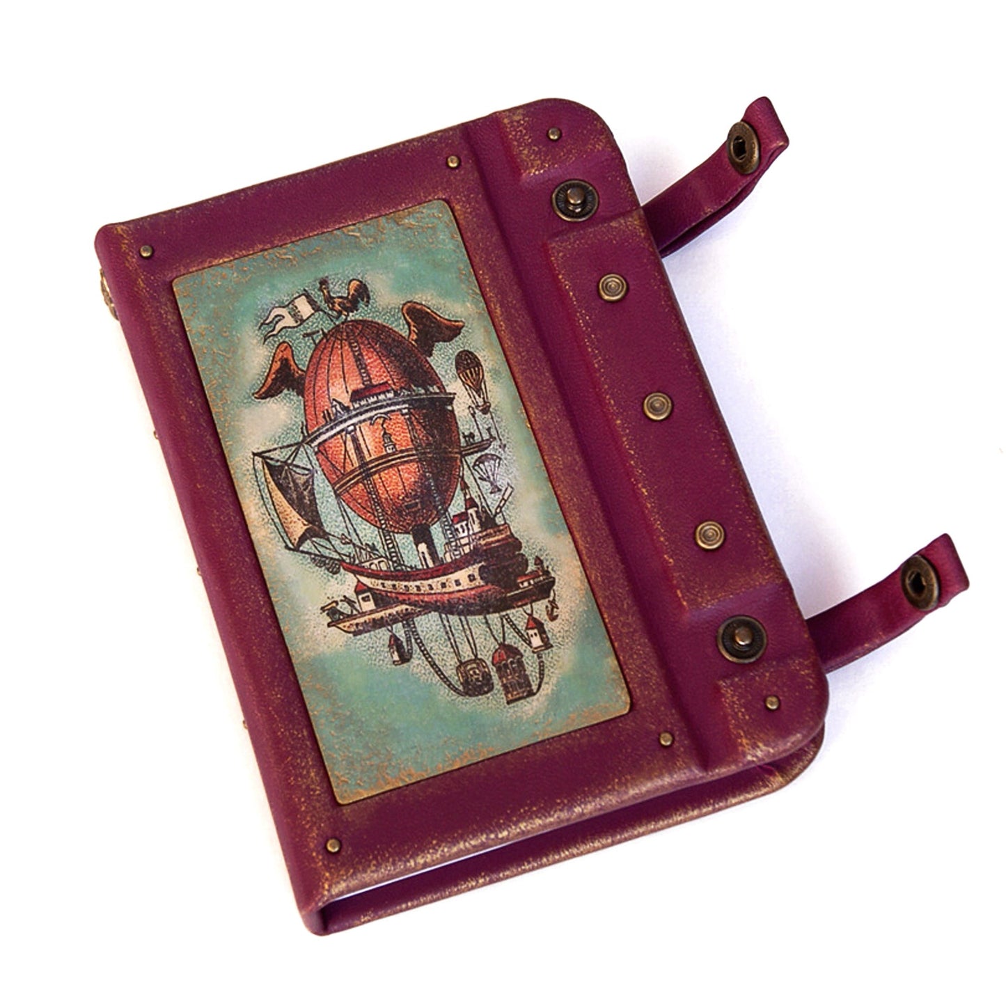 Leather-bound book with a steampunk design on a white background