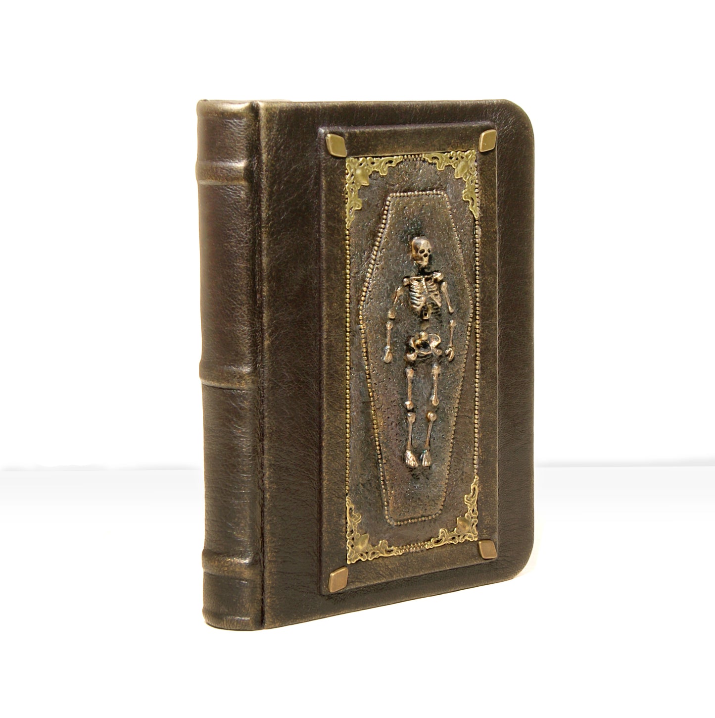 Decorative book with a skeleton in a coffin design on a white background