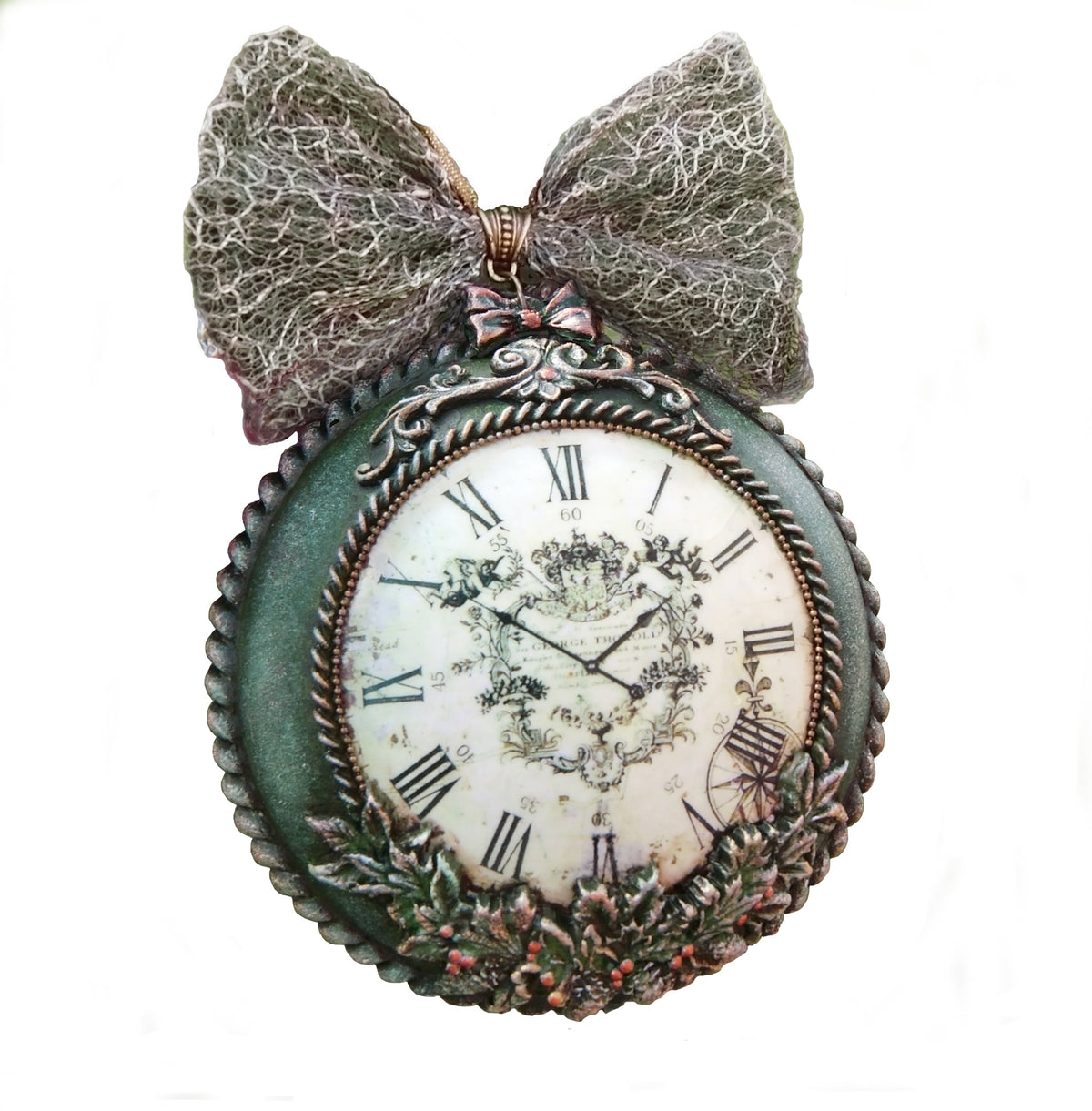 An antique-style decorative medallion- clock with a large textured gray bow on top, featuring a distressed green frame, Roman numerals, and a floral crest on the clock face.