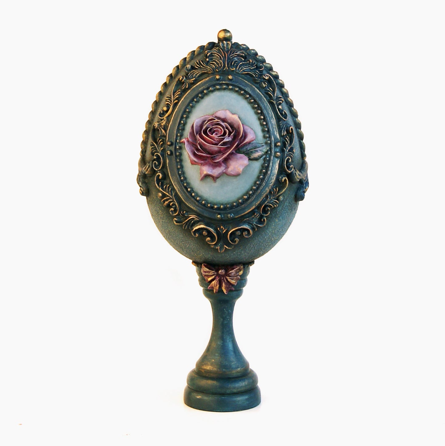 Decorative object with a rose design in an ornate frame on a white background
