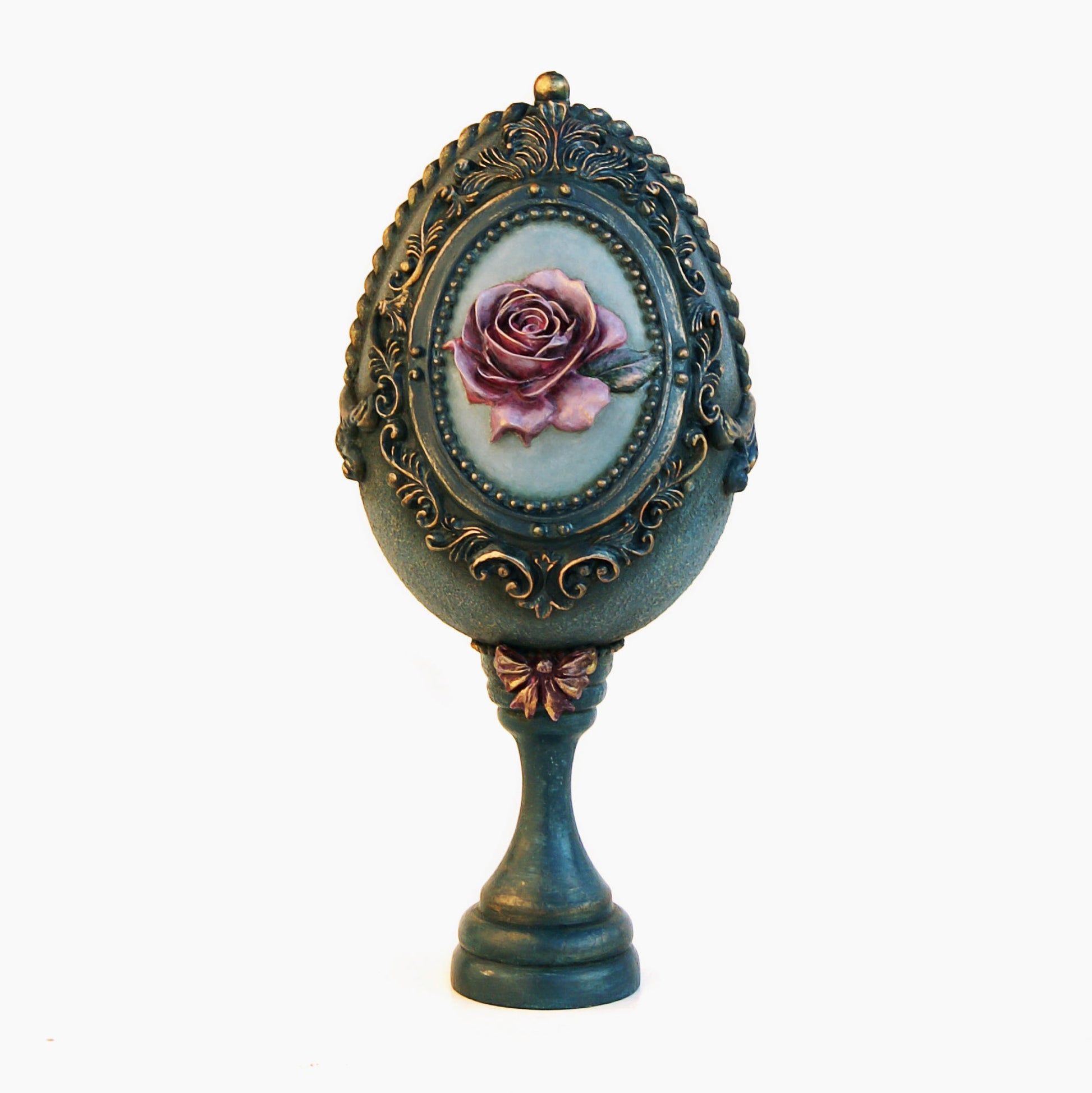 Decorative object with a rose design in an ornate frame on a white background