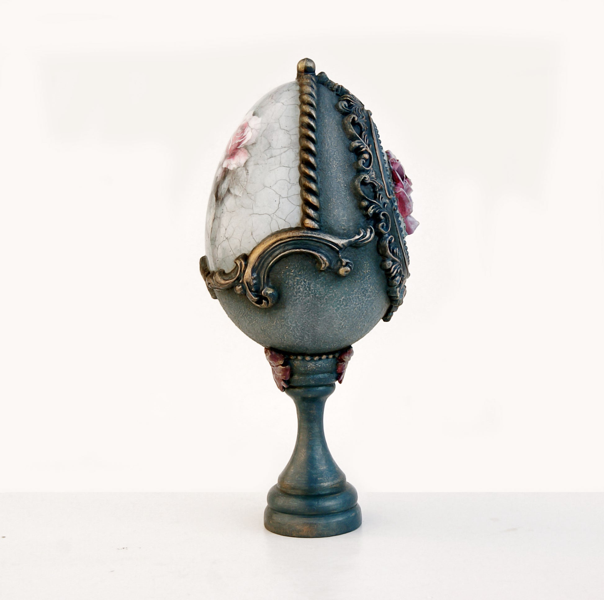 Decorative egg with floral designs and ornate detailing on a white background