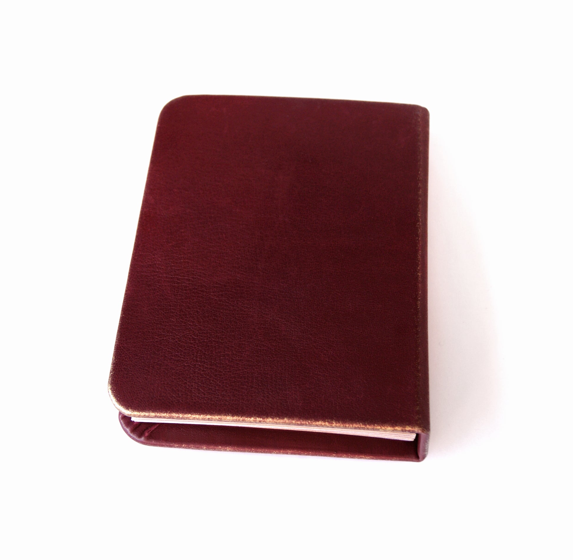 Maroon leather notebook on a white background