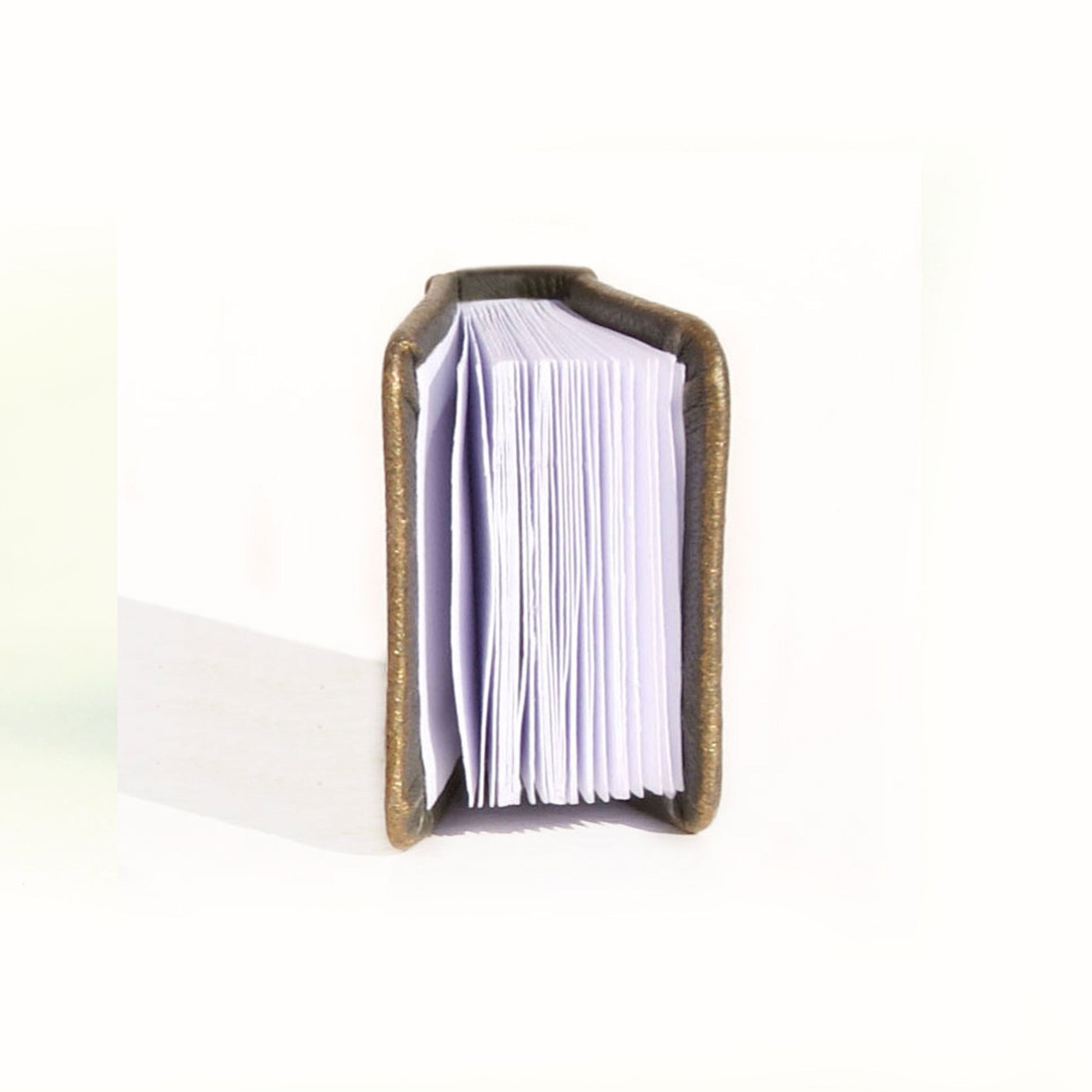 Small open book with a wooden cover on a white background